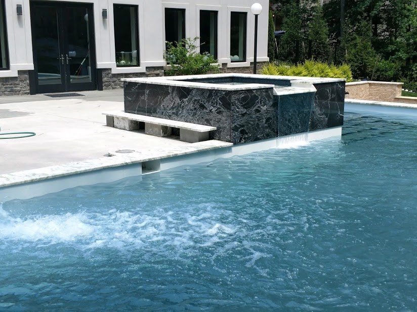 A large swimming pool with a waterfall in the middle