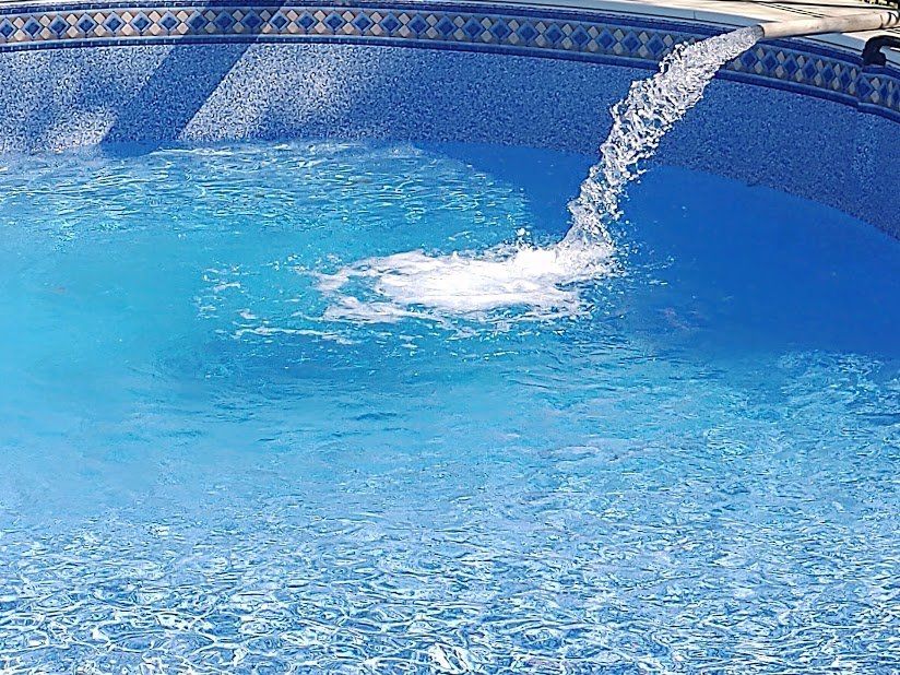 A swimming pool with a waterfall coming out of it