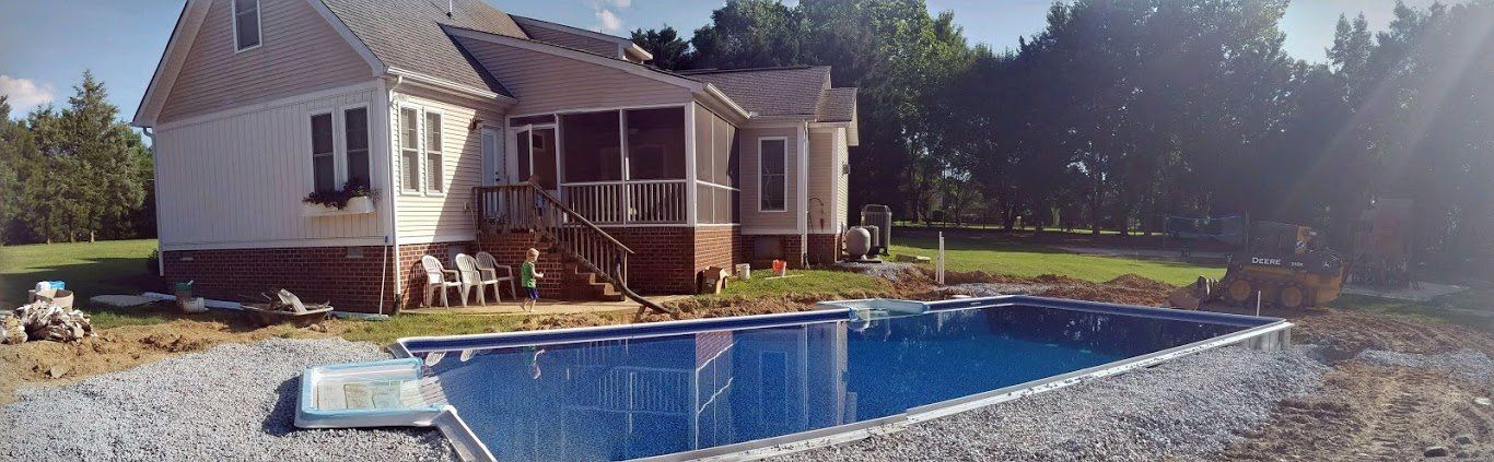 A house with a swimming pool in front of it