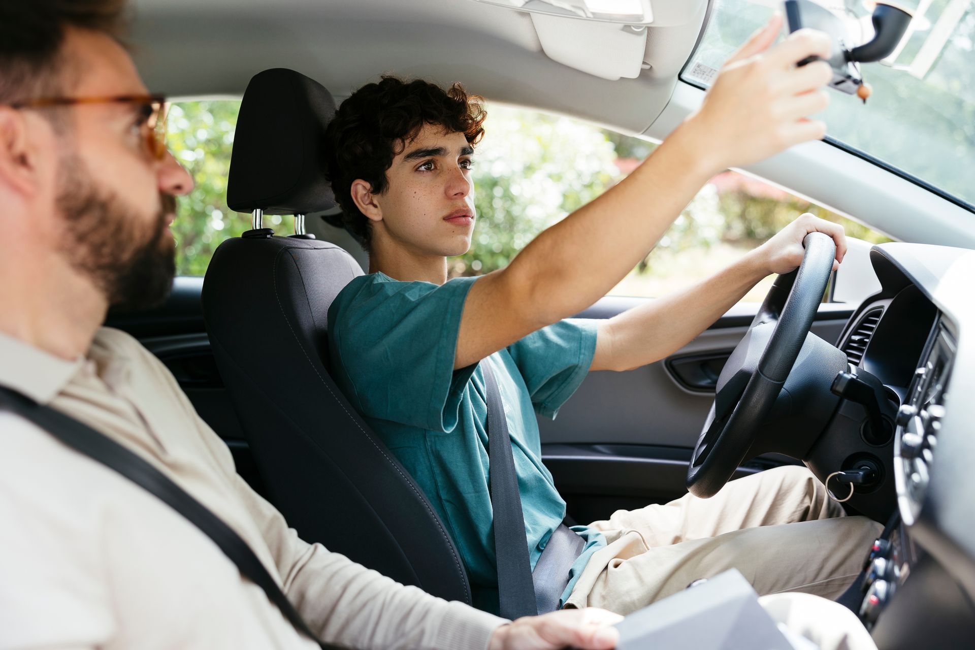 A teen is learning to drive. A teen is learning to drive.