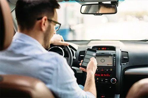 Man Driving While Texting — Tucker, Ga — Taggart's Driving School