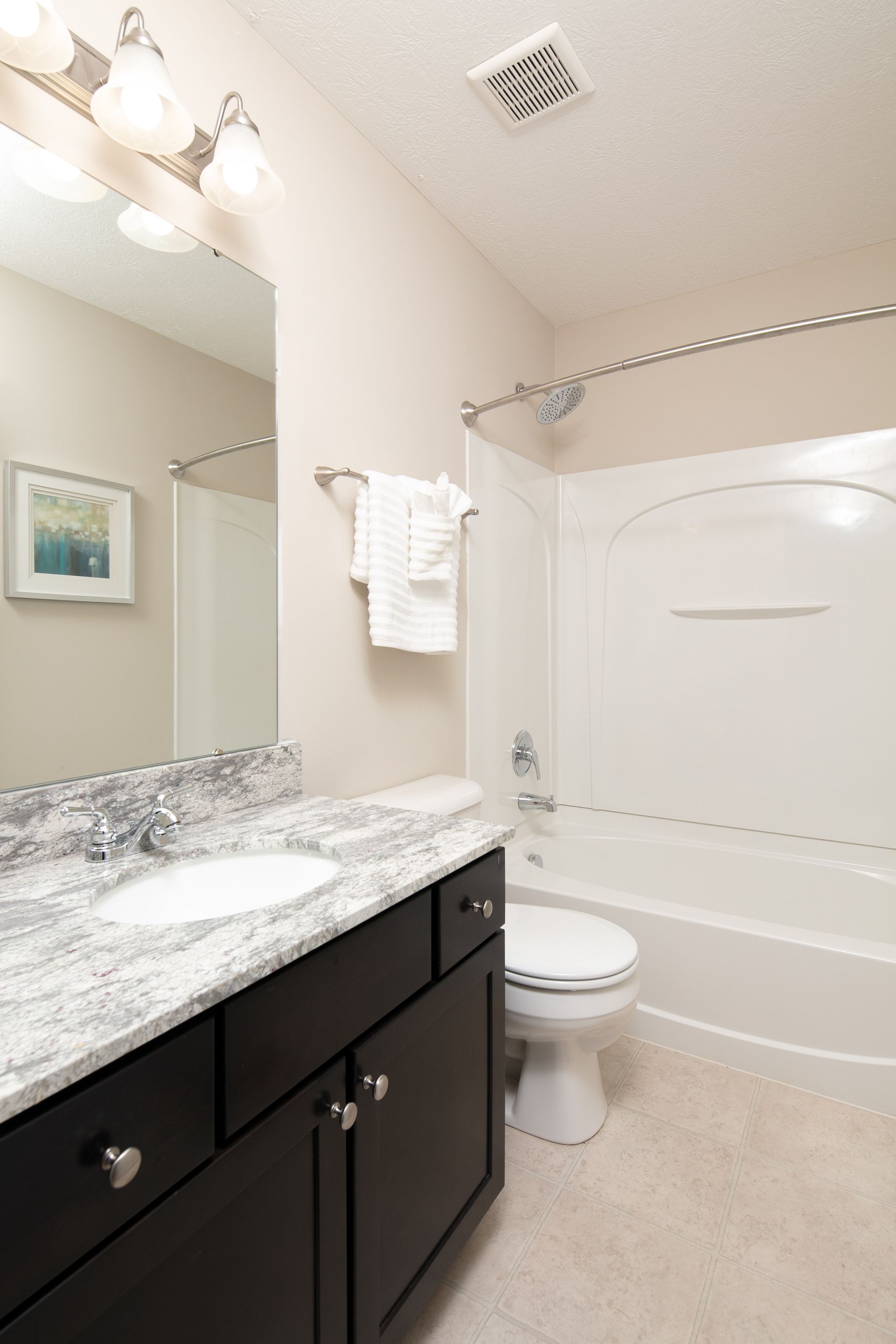 A bathroom with a sink , toilet and bathtub