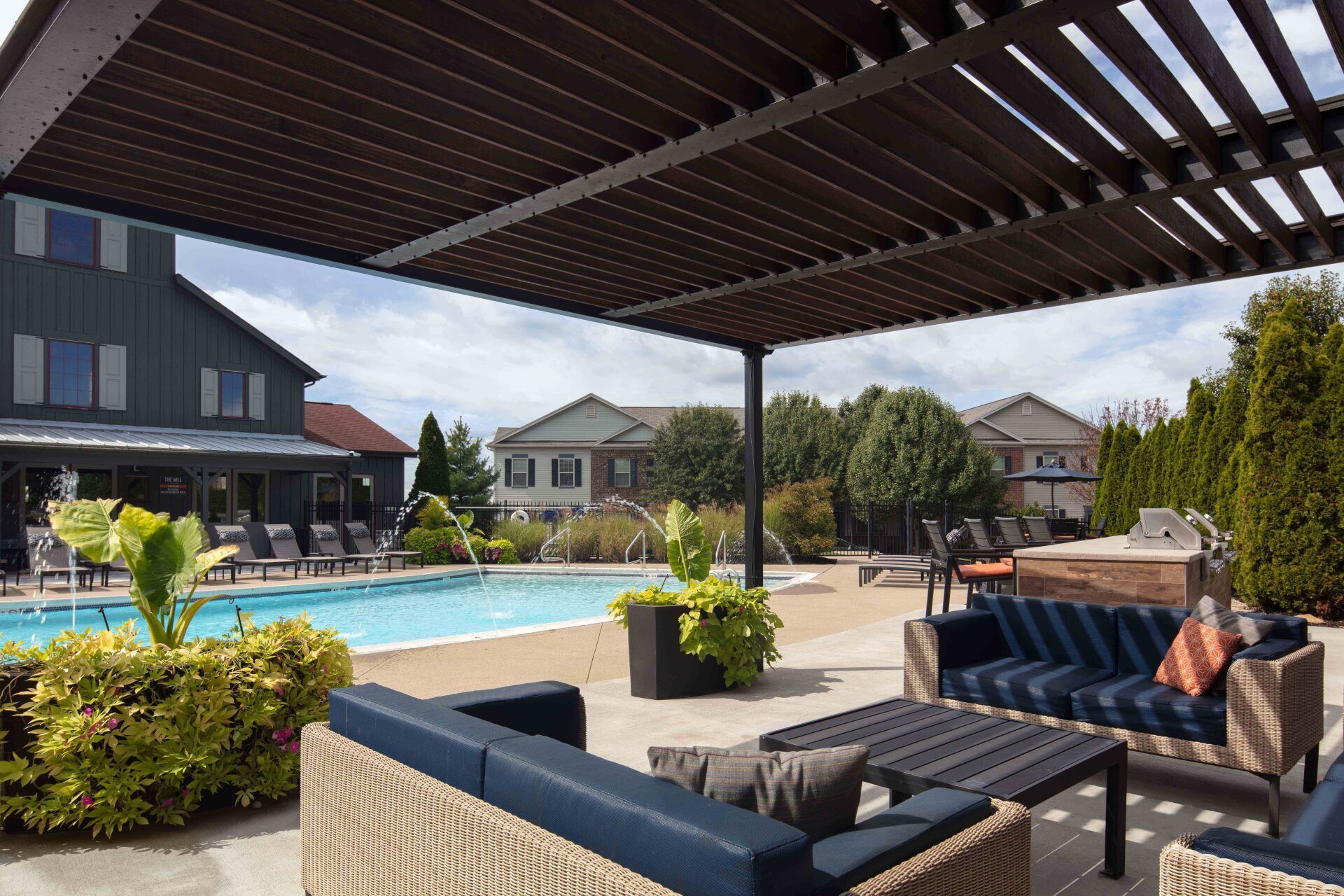 A patio area with a swimming pool and a pergola at The Mill at Georgetown.
