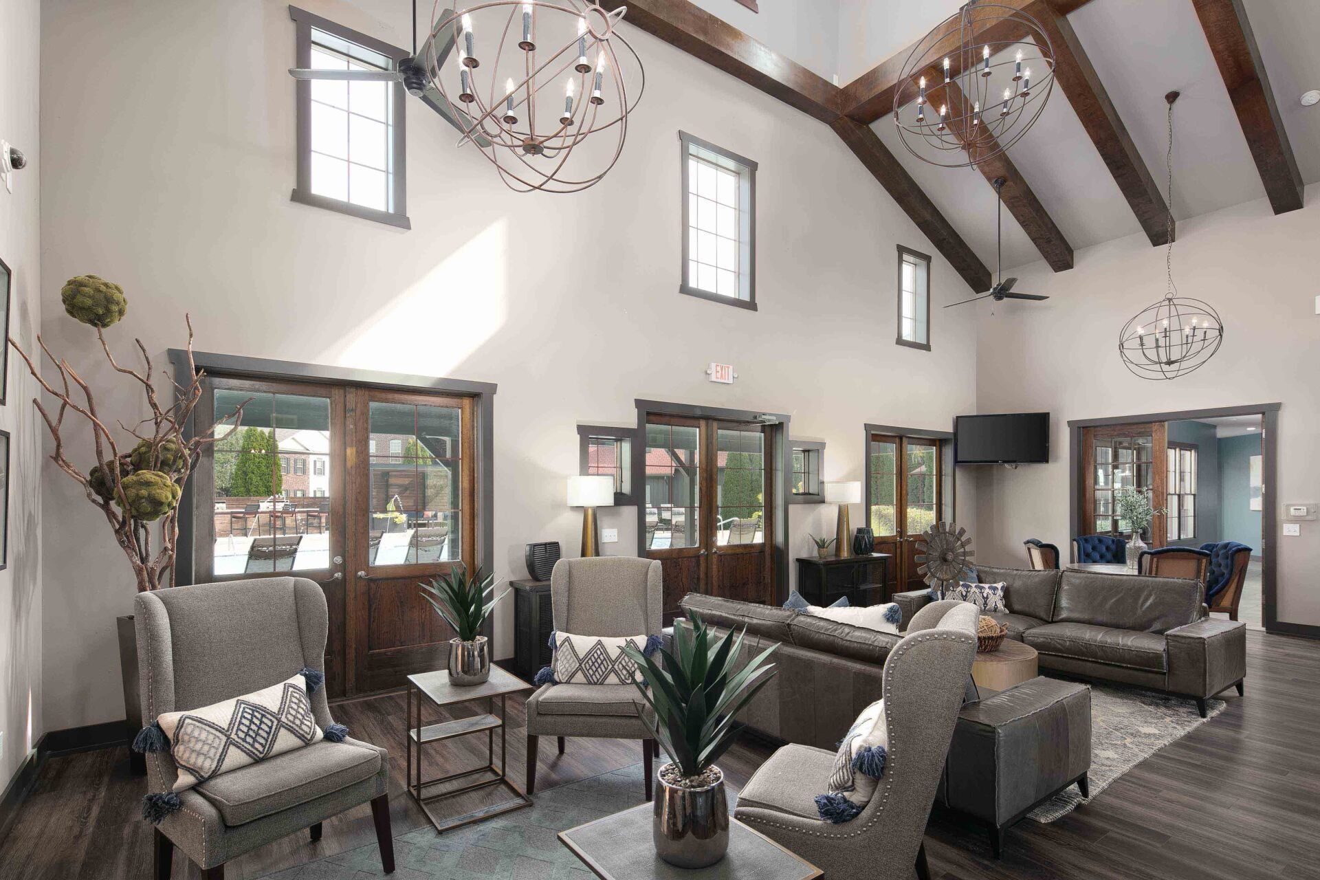 A living room with a lot of furniture and a vaulted ceiling