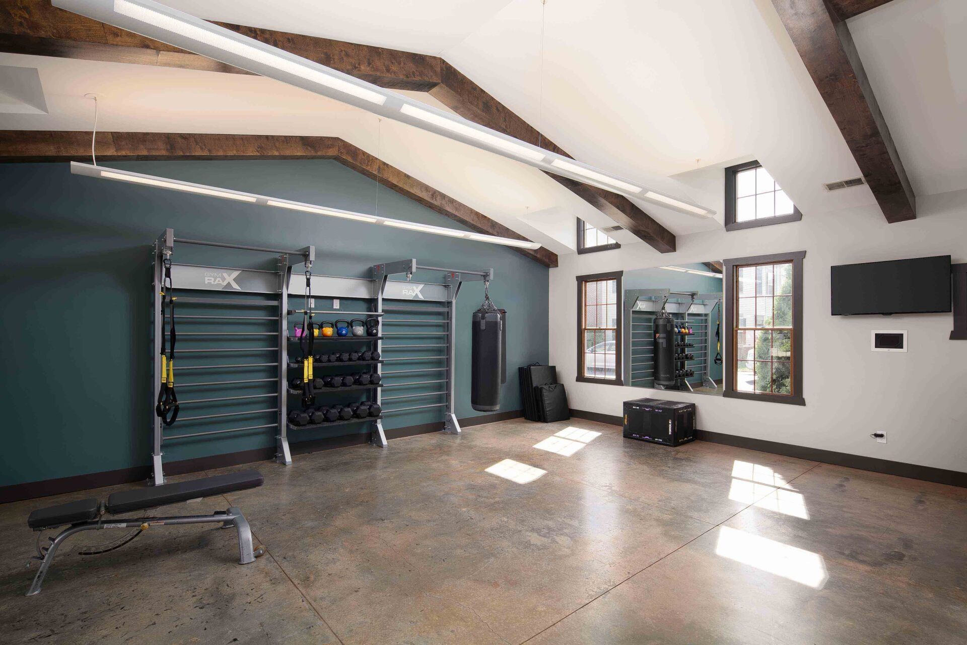 A large room with a lot of windows and a mirror.