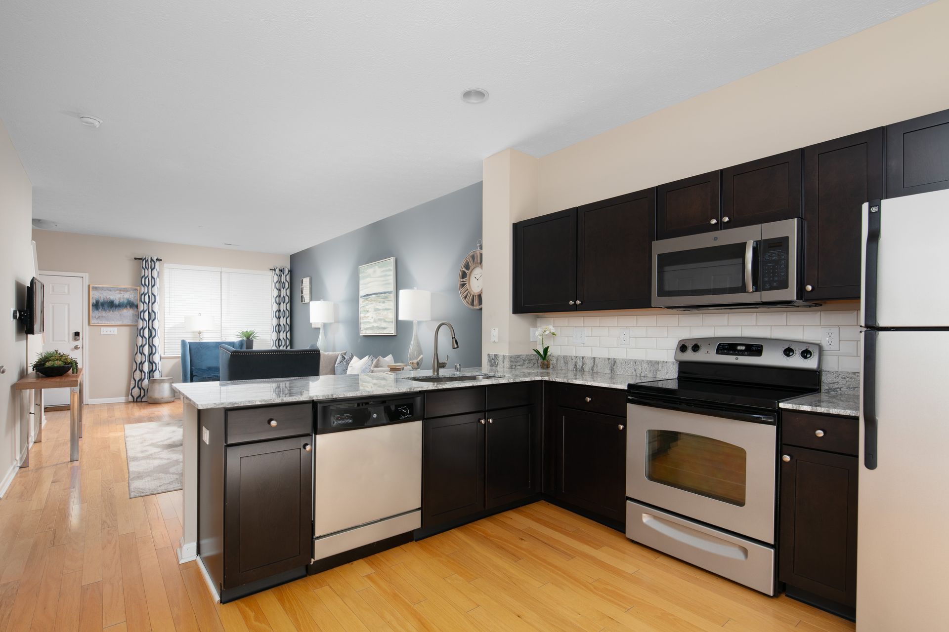 A kitchen with stainless steel appliances and black cabinets
