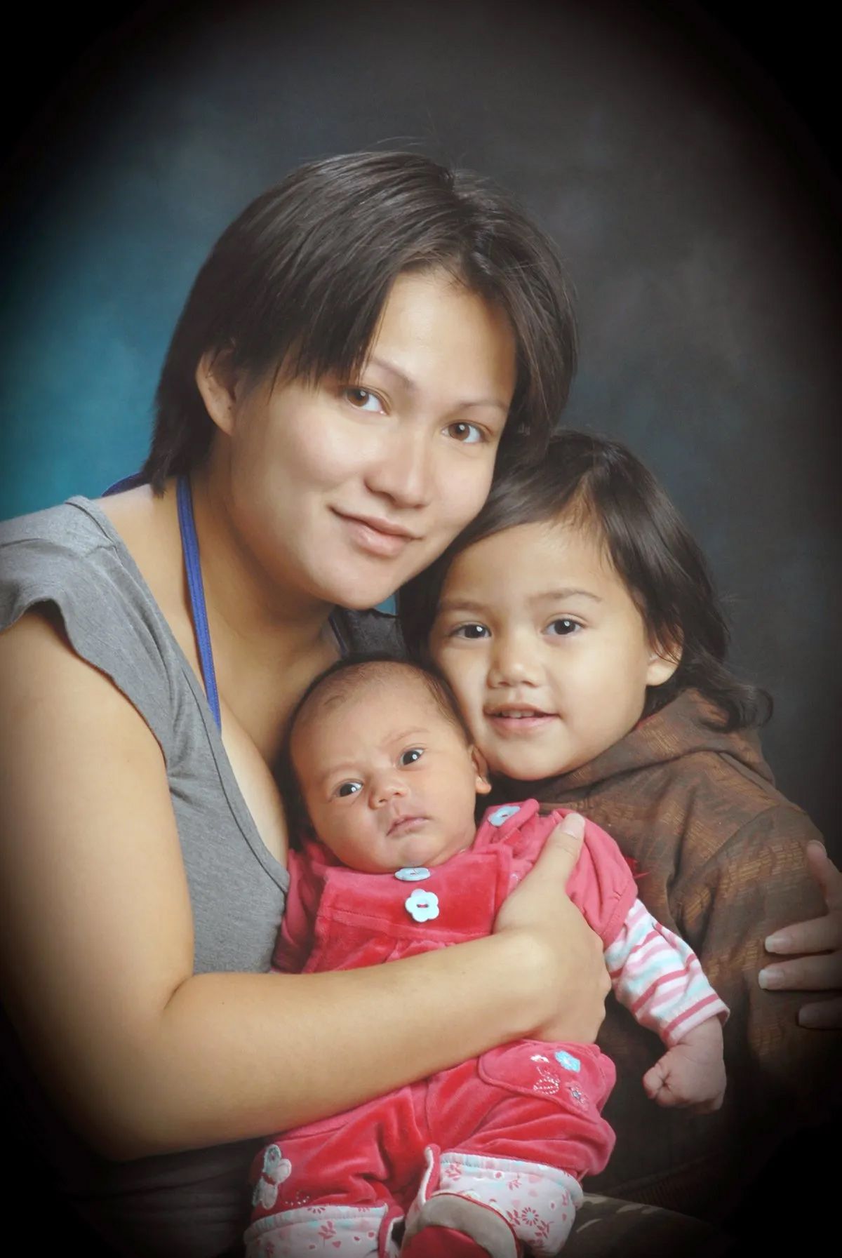 A Mother Hugging her Children