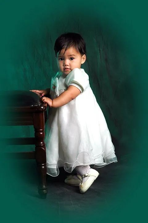 A Baby in a White Dress and Shoes