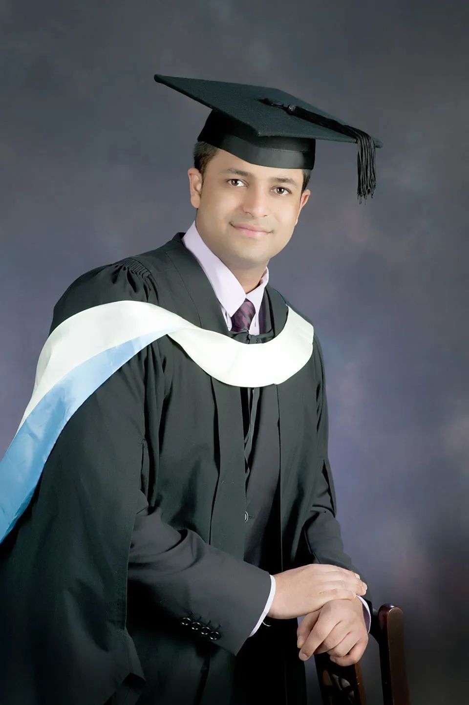 Smiling Man with Graduation Attire