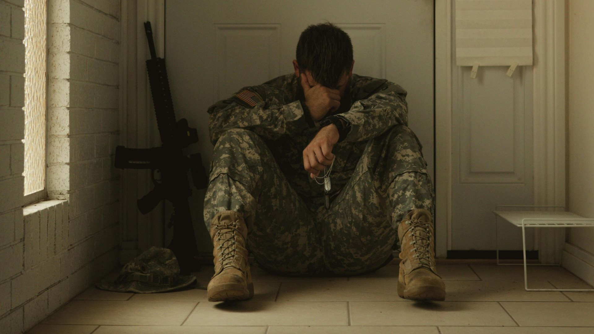 A man and a woman are sitting at a table looking at a piece of paper.