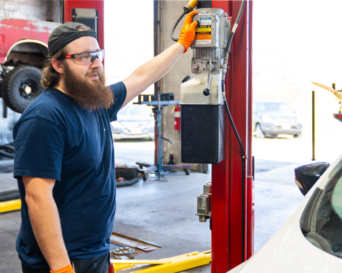 Our expert technician smiling inside of our garage in Grandview, MO | Jerry's Auto Repair