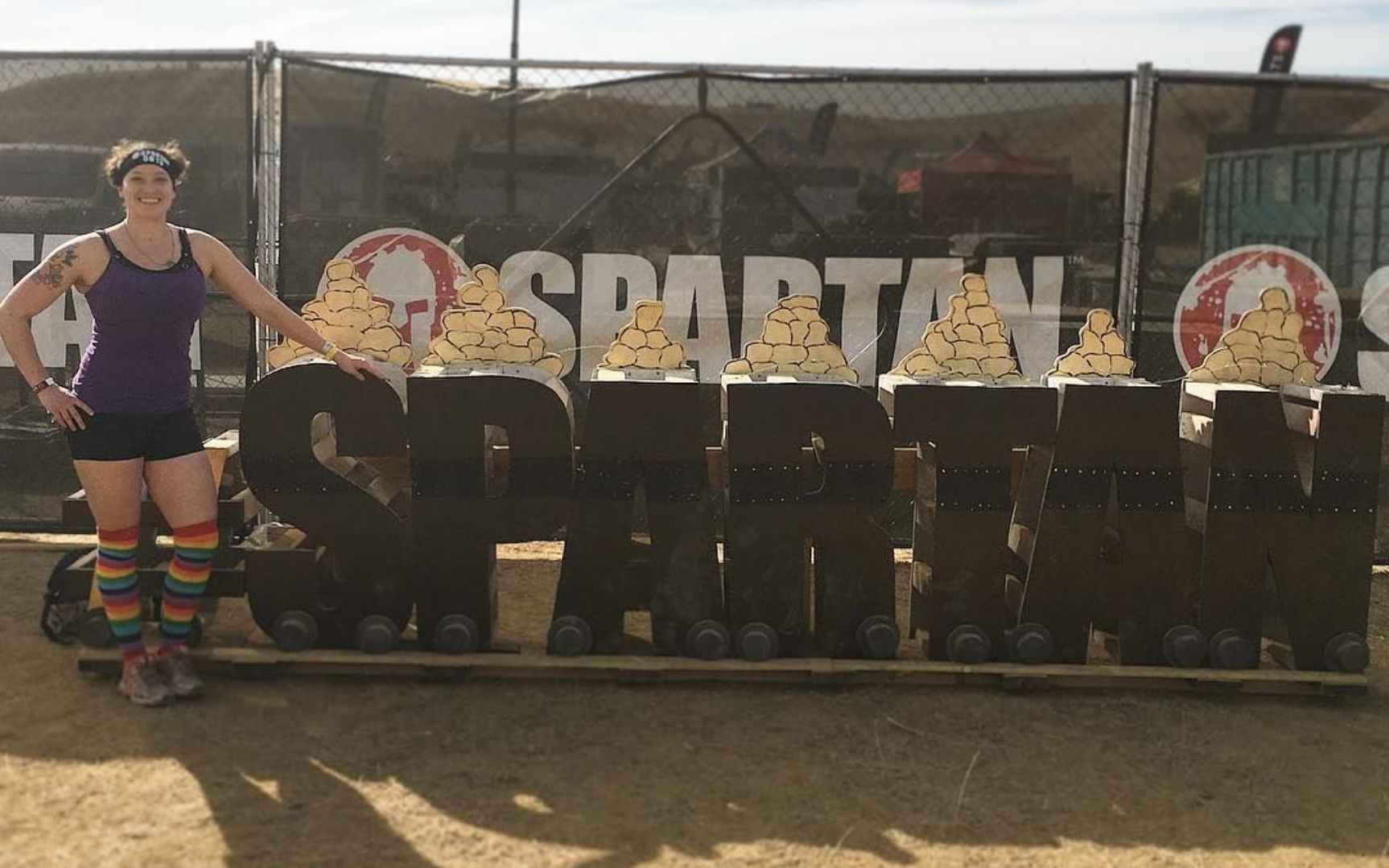 Person doing yoga on a mat, feet visible, with gray leggings, arms extended.