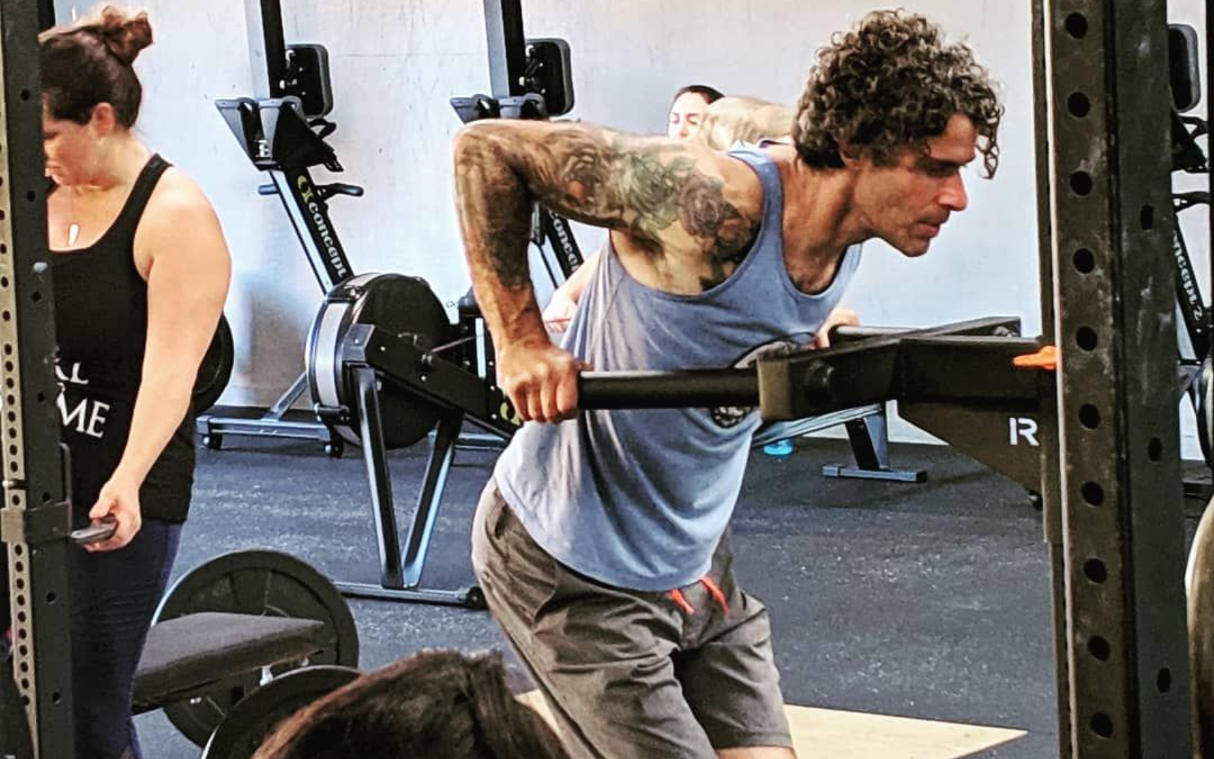 People doing yoga in a studio with raised arms.