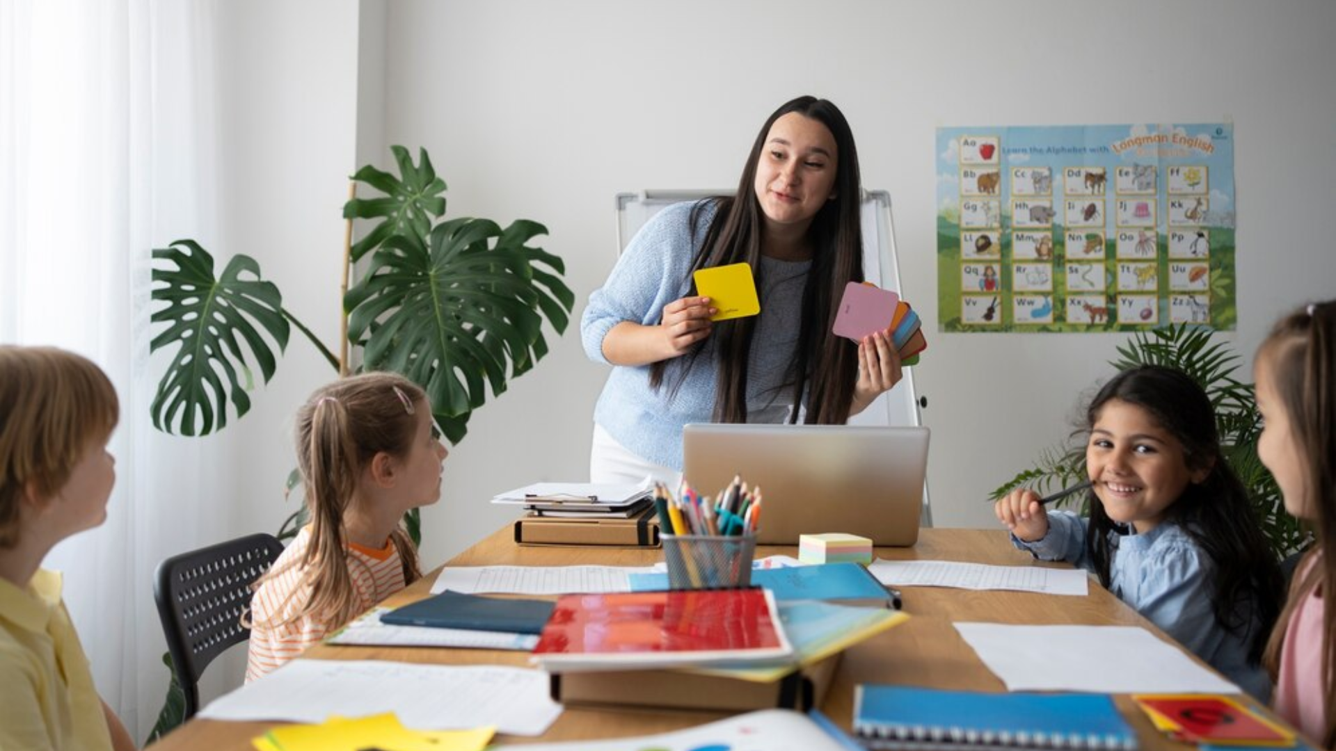 A teacher is teaching a group of children in a classroom.