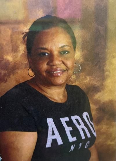 A woman wearing a black aeropostale shirt is smiling for the camera.