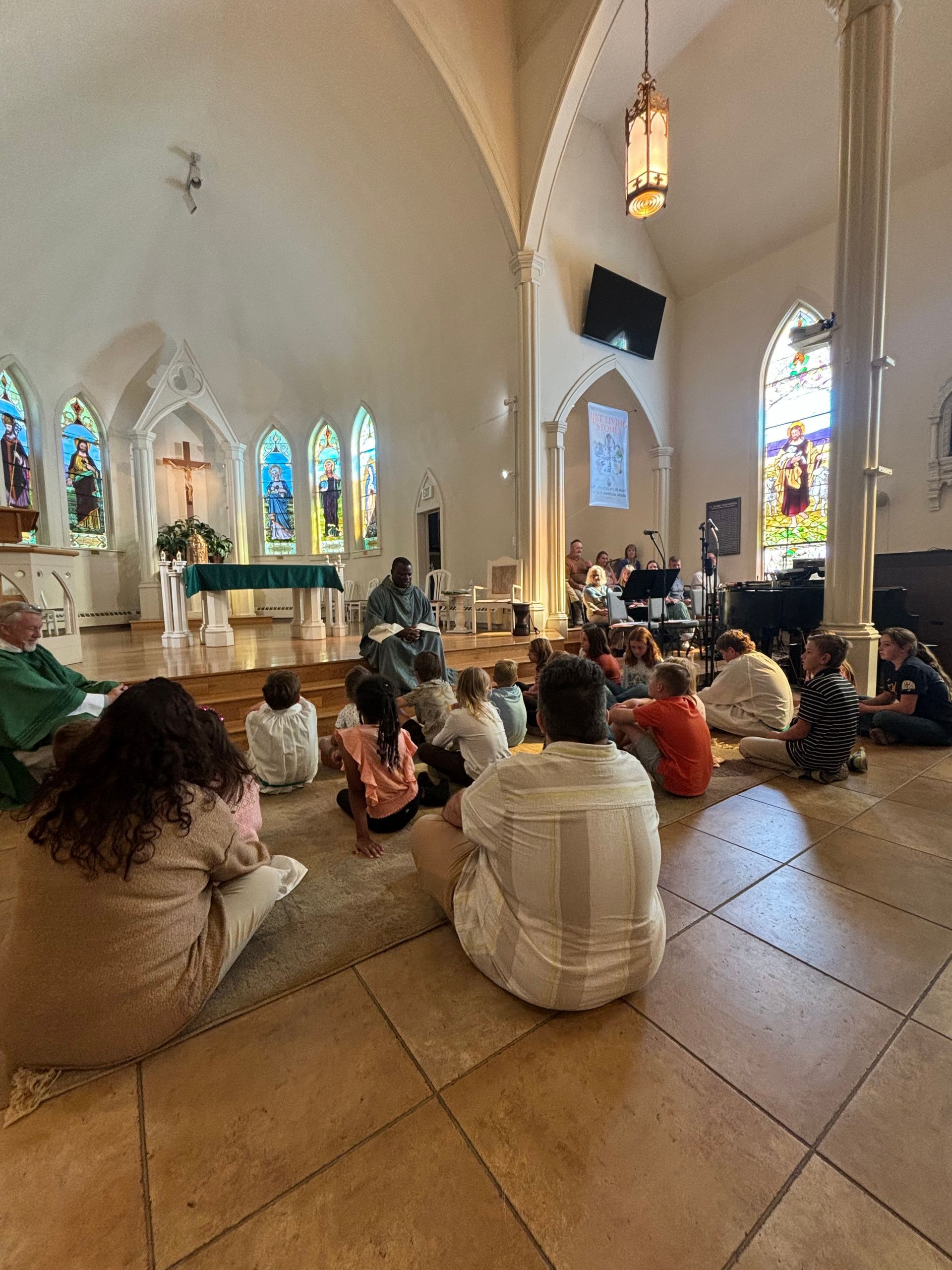 Three crosses are sitting on top of a mountain overlooking a lake.
