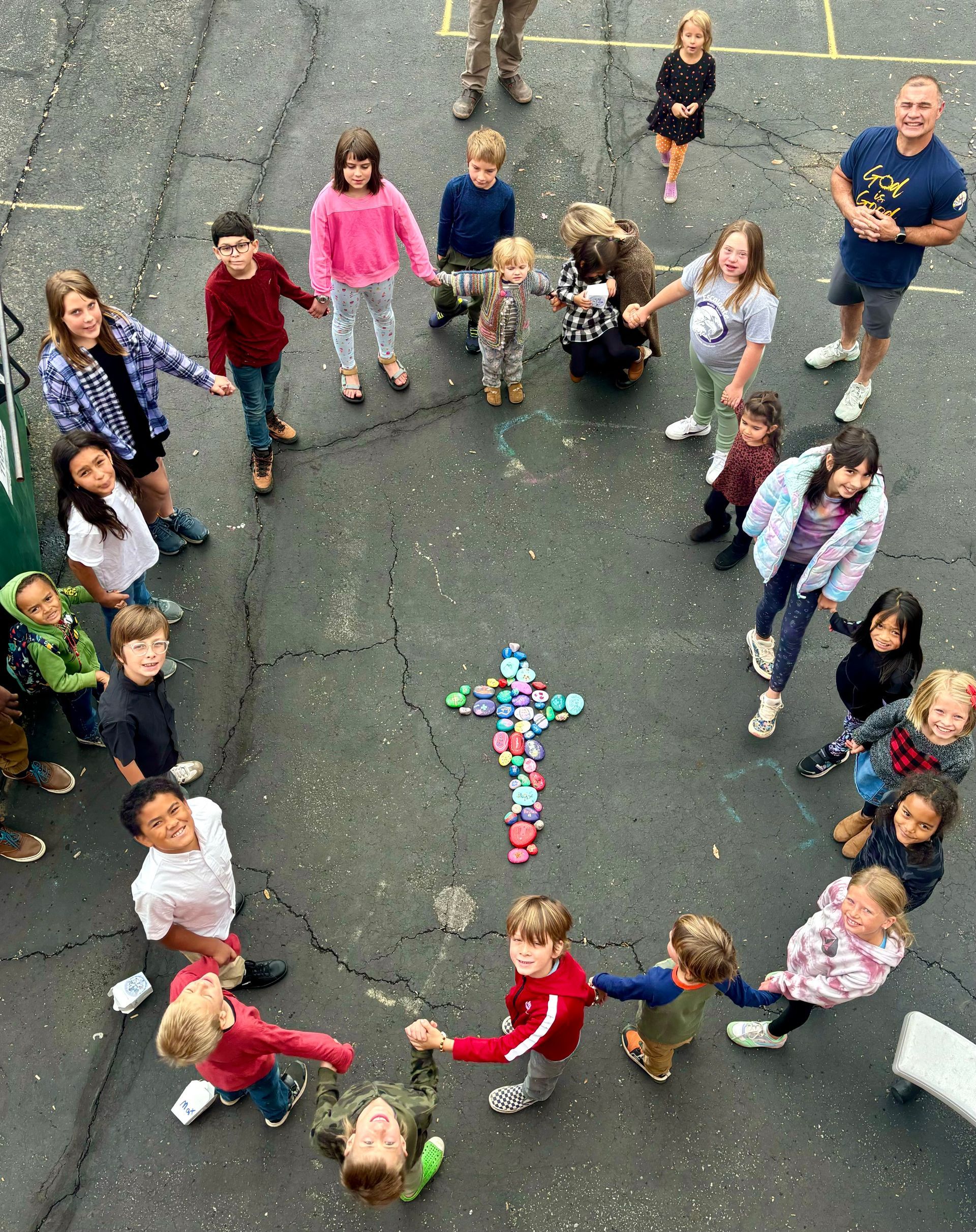 A group of people are standing on top of a hill with their arms around each other.