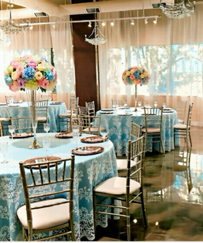 Table set with glasses and napkins, outdoors, blurred background with lights. Table set with glasses and napkins, outdoors, blurred background with lights.