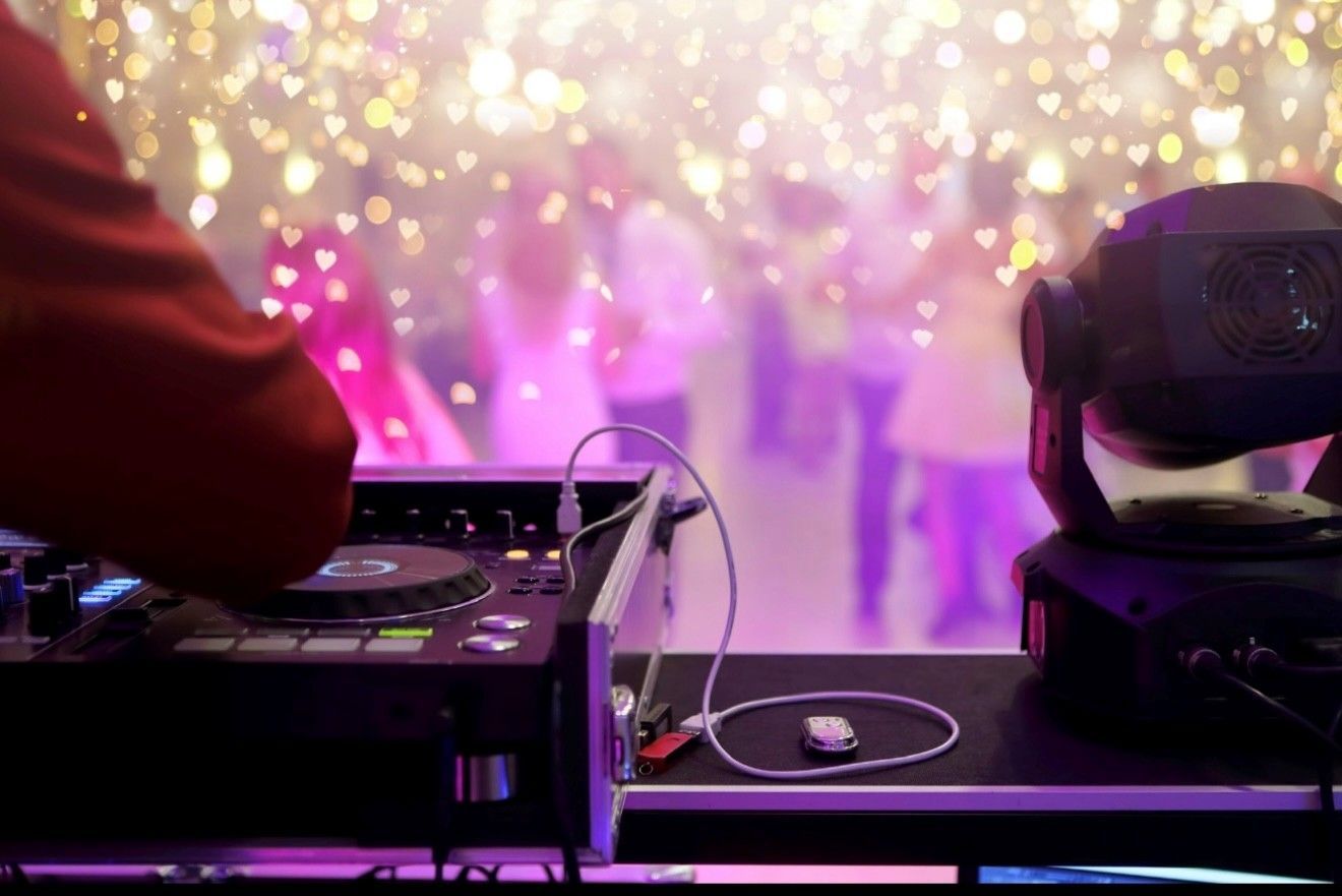 Elegant ballroom with pink tablecloths, silver chairs, and crystal chandeliers. Elegant ballroom with pink tablecloths, silver chairs, and crystal chandeliers.