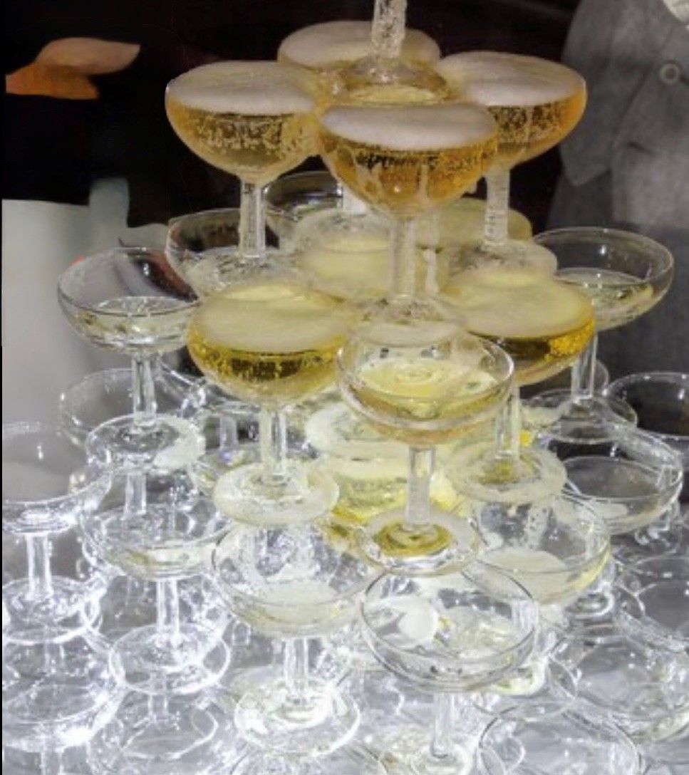 Buffet with appetizers, vegetables, and fruit. Fried food served in clear cups, alongside chips and sliced vegetables. Buffet with appetizers, vegetables, and fruit. Fried food served in clear cups, alongside chips and sliced vegetables.