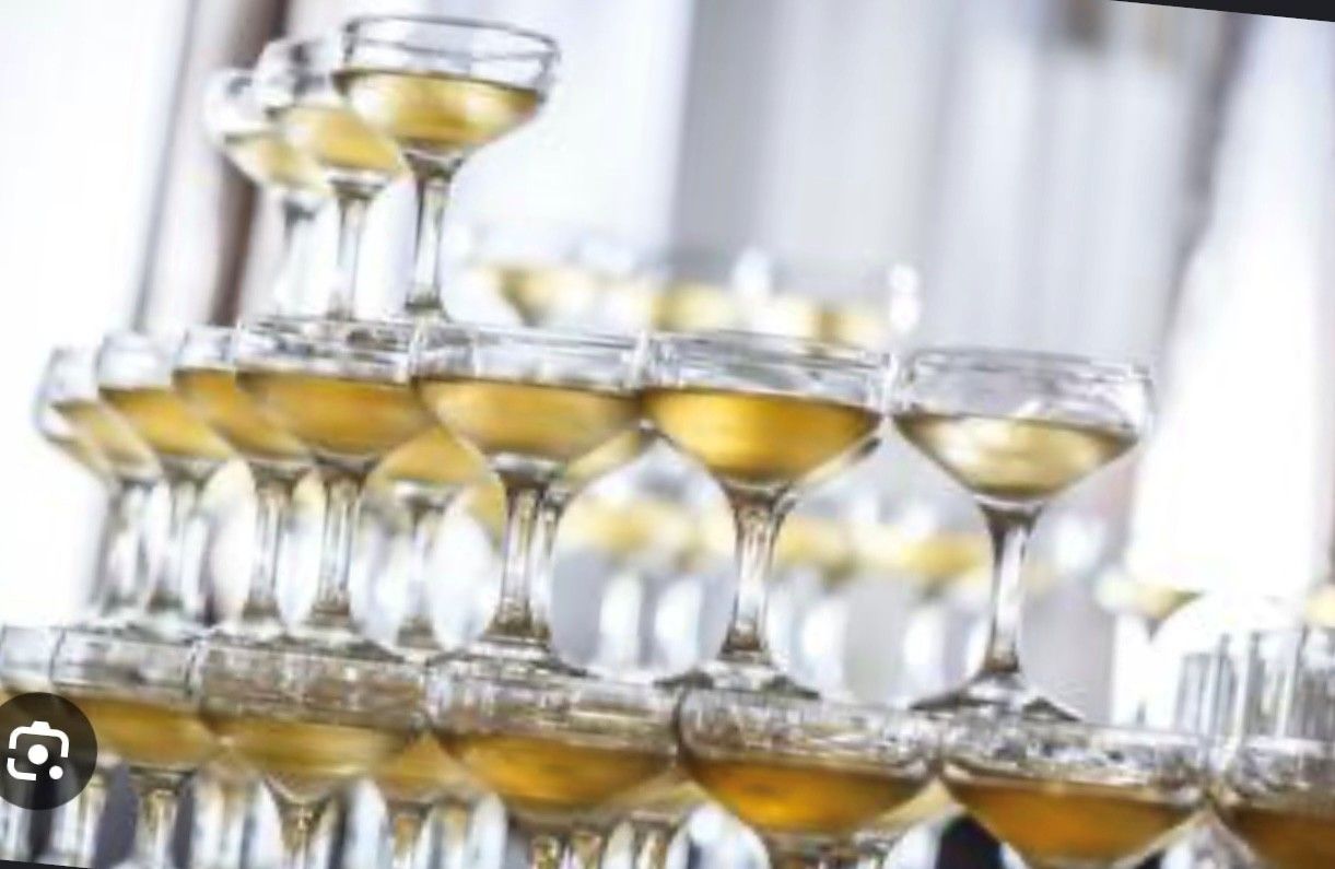 A luxury event space with a grand piano, chandeliers, and decorative wall panels. A luxury event space with a grand piano, chandeliers, and decorative wall panels.