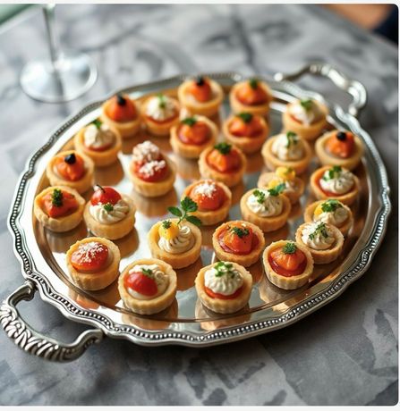 Waiter carrying a tray with a bowl of food and a dessert glass in a restaurant setting. Waiter carrying a tray with a bowl of food and a dessert glass in a restaurant setting.
