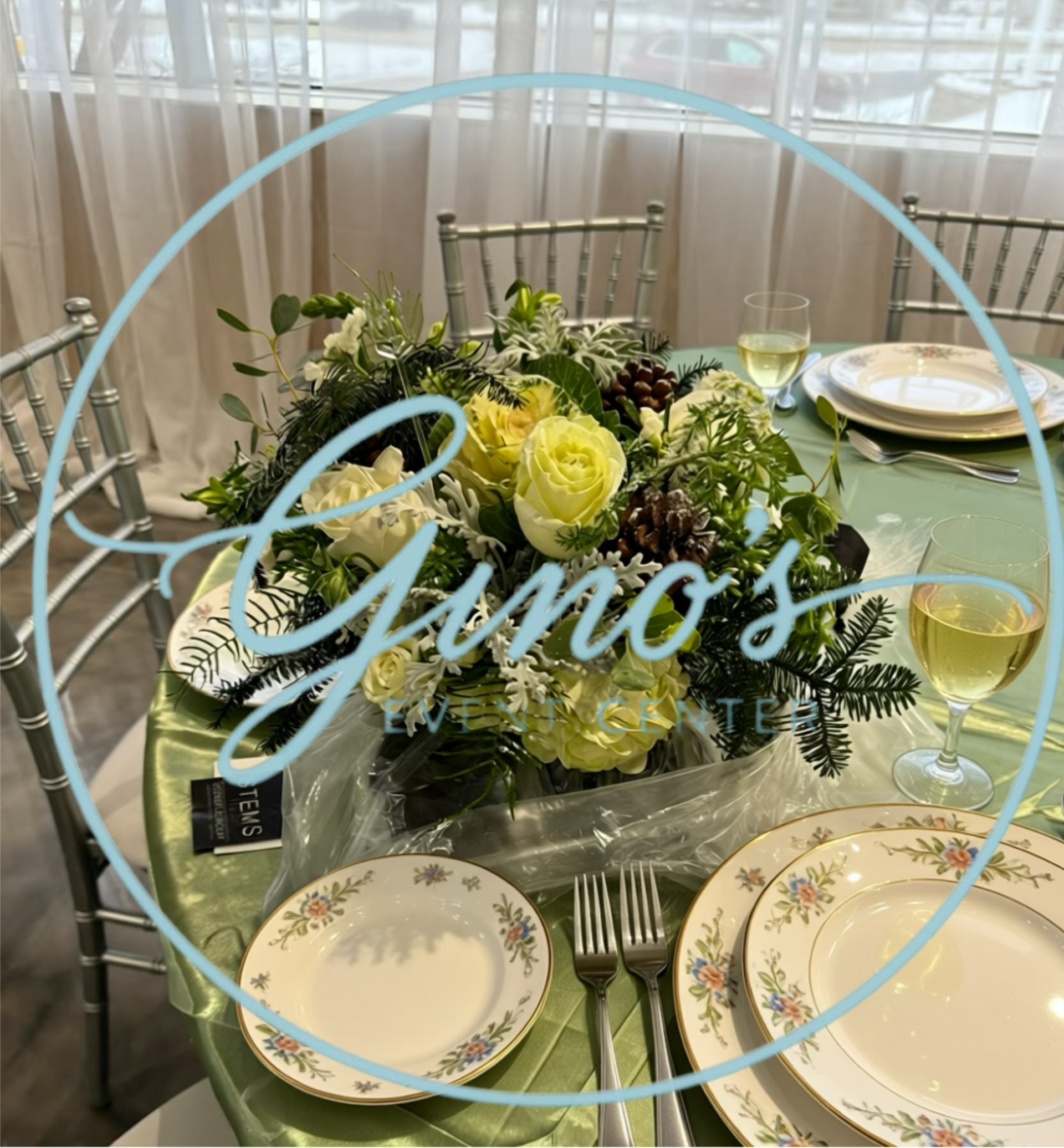 Table setting with floral centerpiece and place settings at Gino's restaurant.