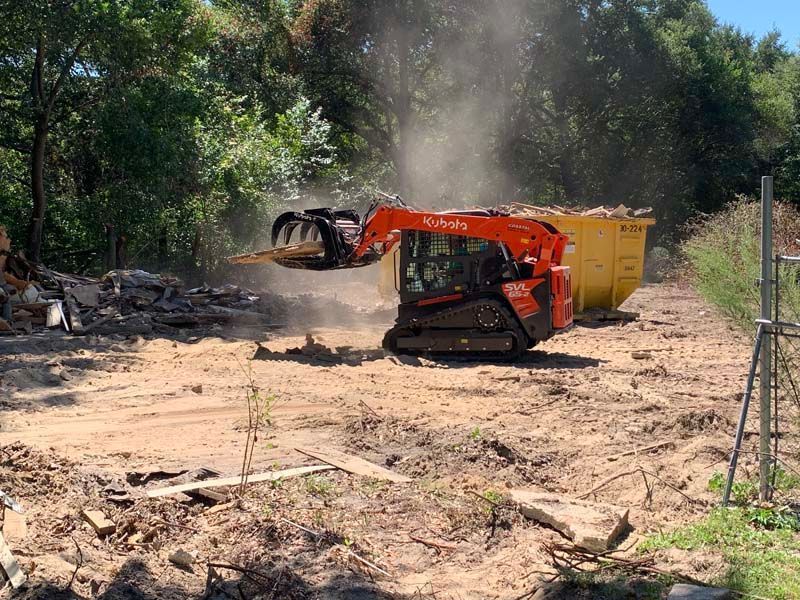 A bulldozer is moving dirt in a dirt field.