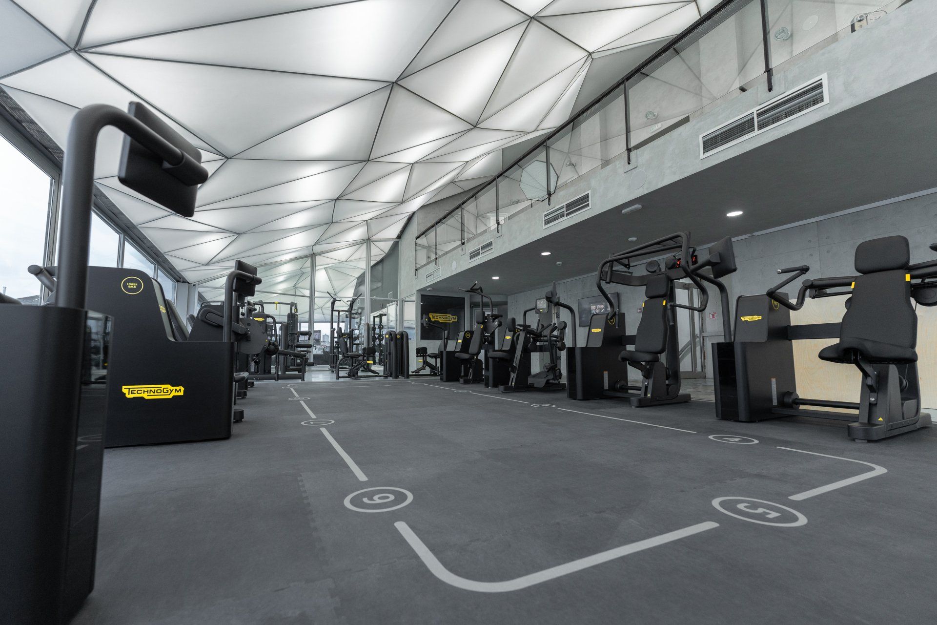 a large gym with a lot of exercise equipment