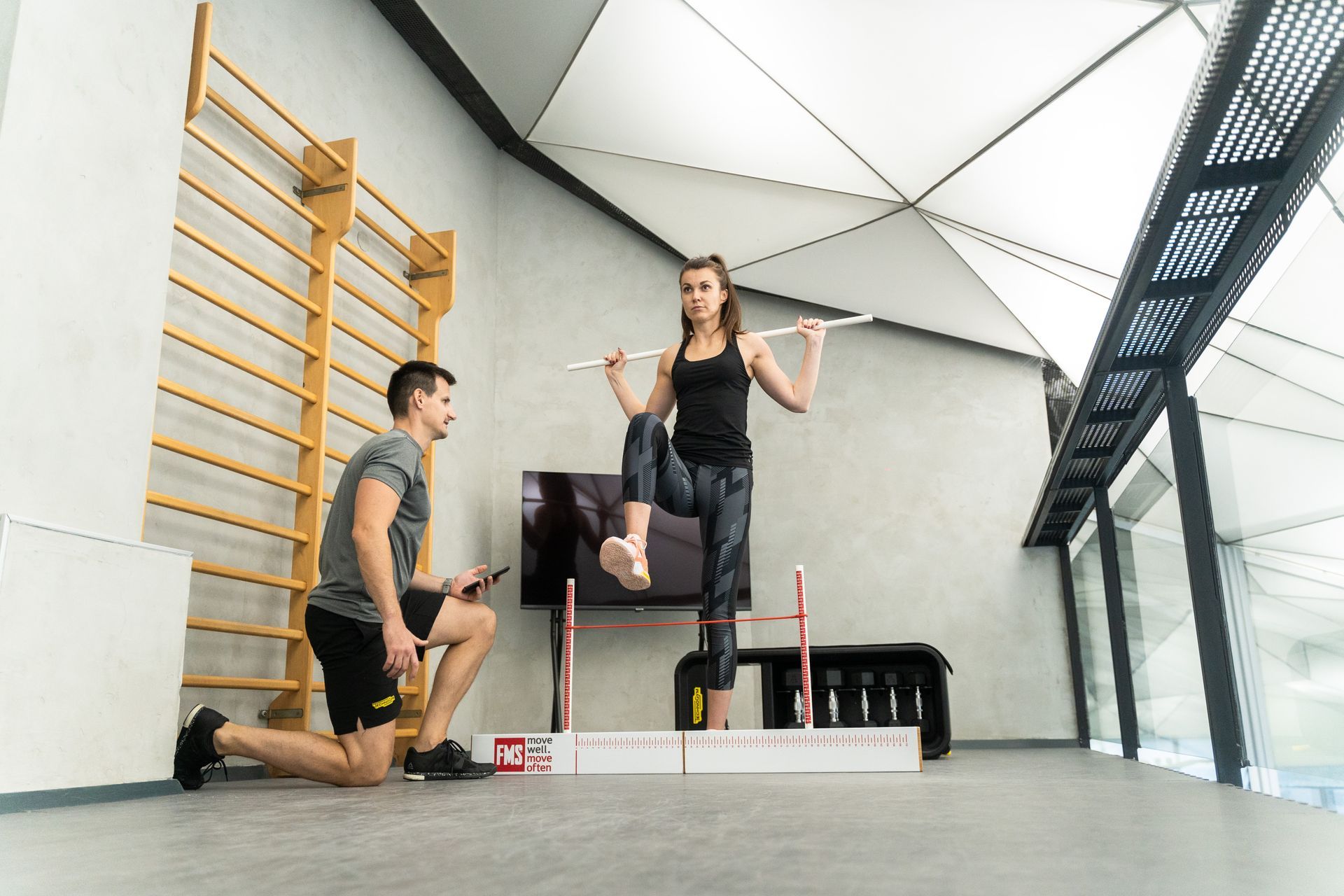 a man and a woman are doing exercises in a gym .