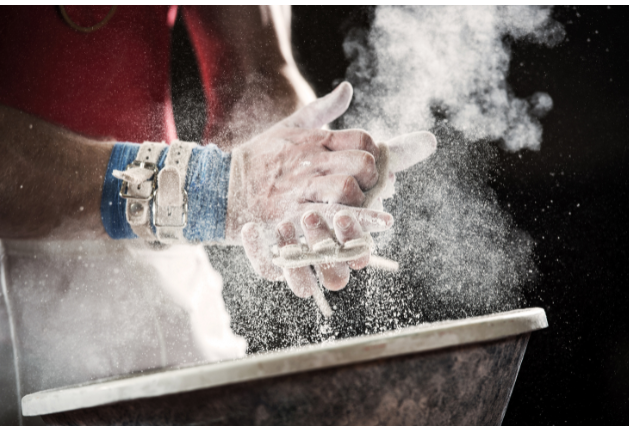 A close up of a person 's hands covered in chalk