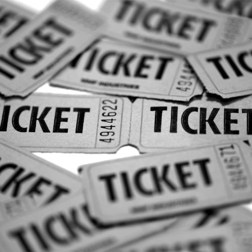 A bunch of tickets are stacked on top of each other