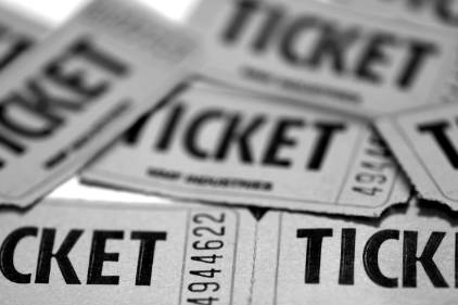 A bunch of tickets are stacked on top of each other