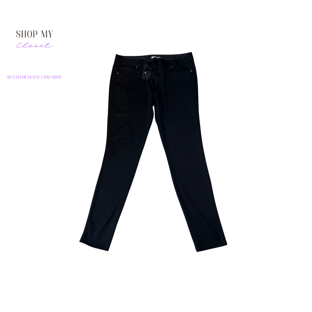 A close-up of a pair of New York and Company Soho cotton burgundy dress pants. The pants are made of a smooth, comfortable fabric and have a straight leg. They are size 12 and are on a hanger. The pants are a deep black color and have a small, white New York and Company logo on the front pocket.