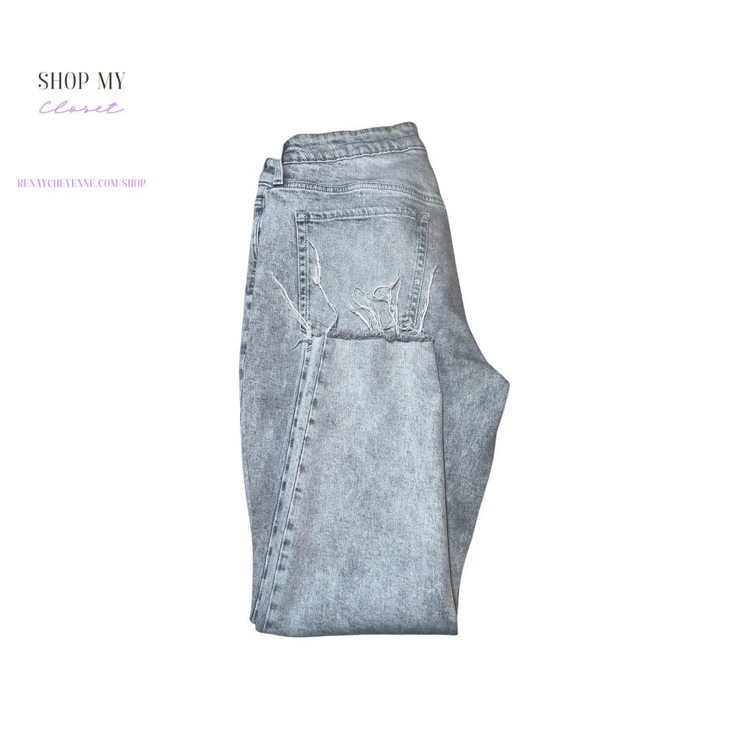 A pair of Old Navy gray wash denim jeans, size 14. The jeans are made of a soft, comfortable denim fabric and have a classic straight leg fit. They are styled with five pockets and a button fly closure. The jeans are a light gray color with a subtle wash.