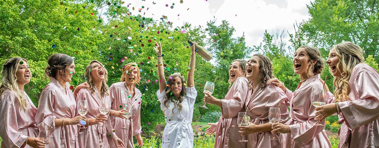 Bride and Bridesmaids celebrating with confetti before wedding ceremony