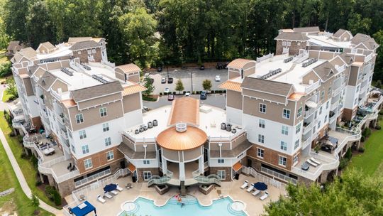 A bedroom with a bed and a ceiling fan