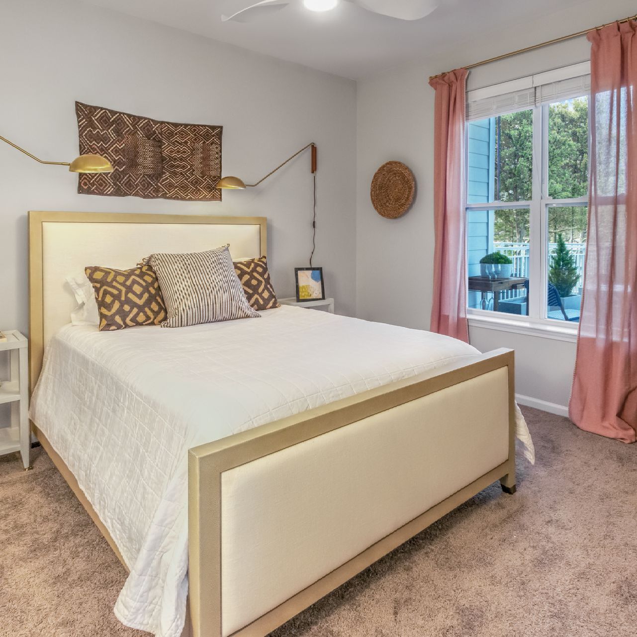 A bedroom with a bed and a ceiling fan