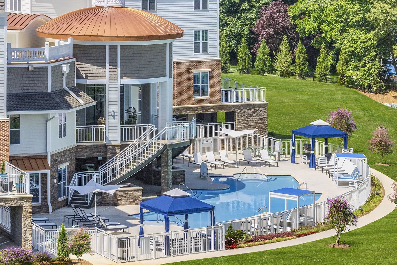 A large house with a large swimming pool in front of it at The Osprey in Mooresville, NC.