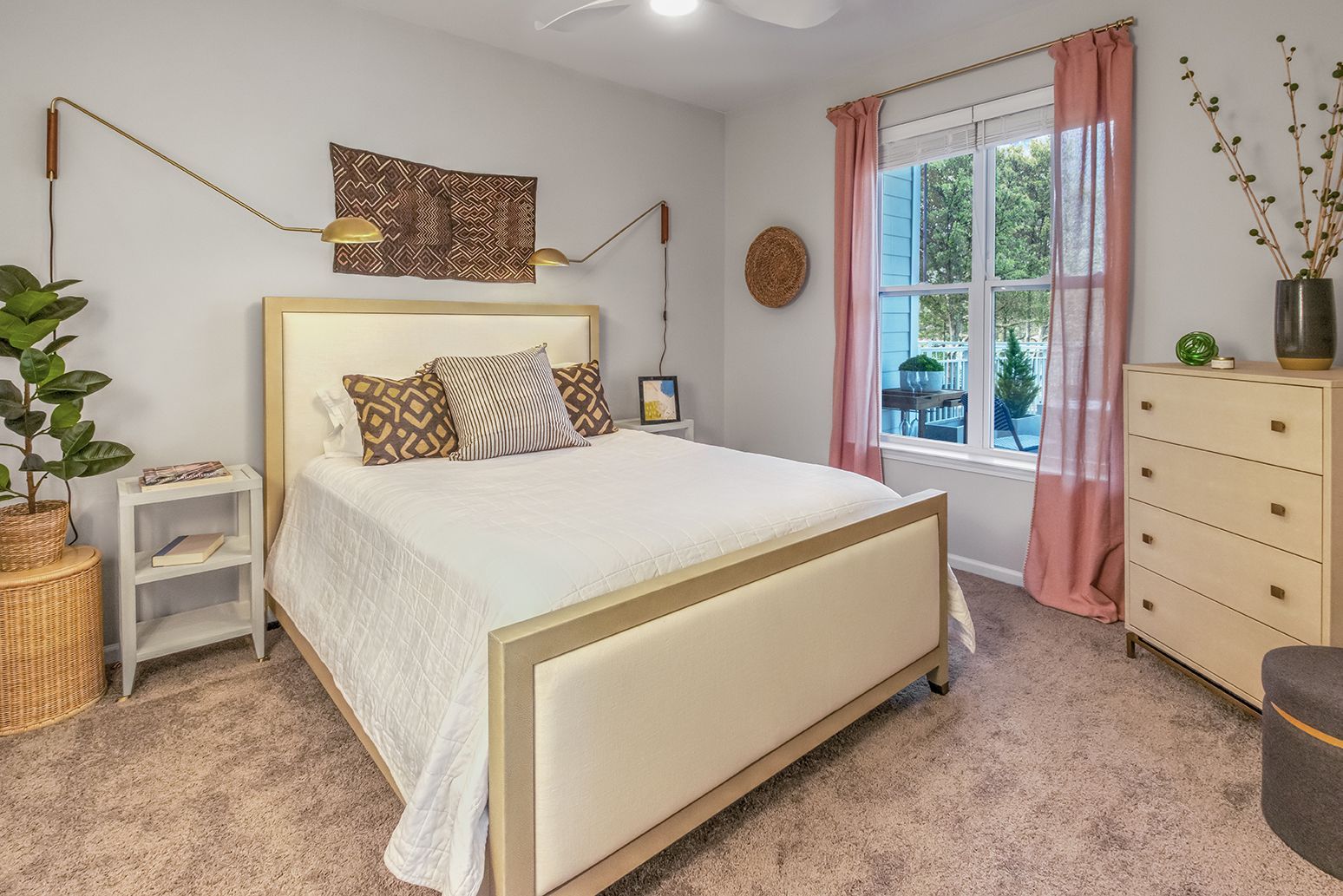 A bedroom with a bed , dresser , nightstand and window at The Osprey in Mooresville, NC.