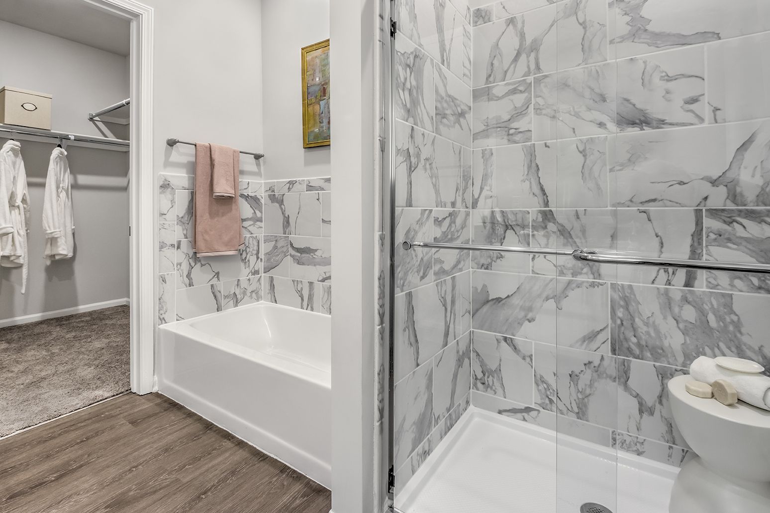 A bathroom with a walk in shower , bathtub and toilet at The Osprey in Mooresville, NC.
