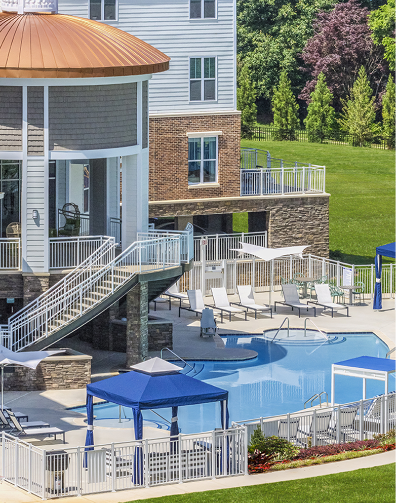 A man wearing a morrison yard t-shirt is lifting a dumbbell