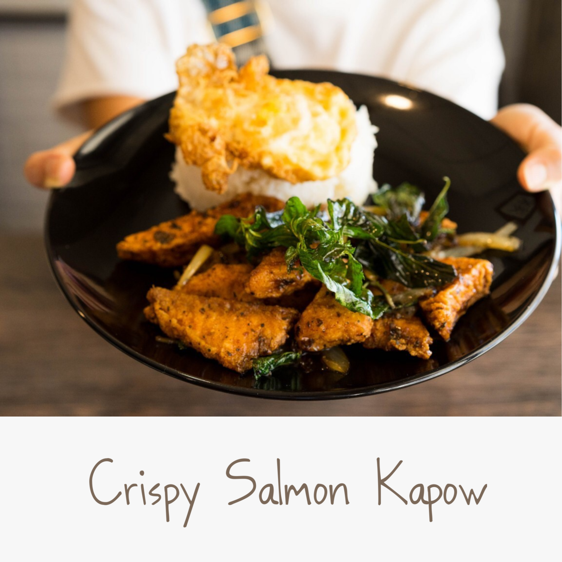 A person is holding a plate of crispy salmon kapow