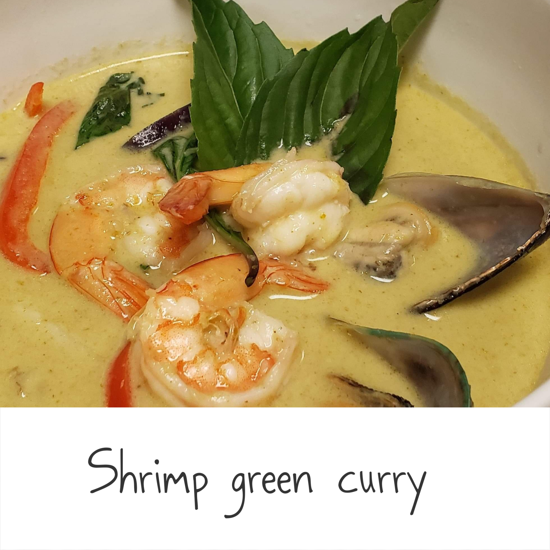 A bowl of shrimp green curry with a spoon in it