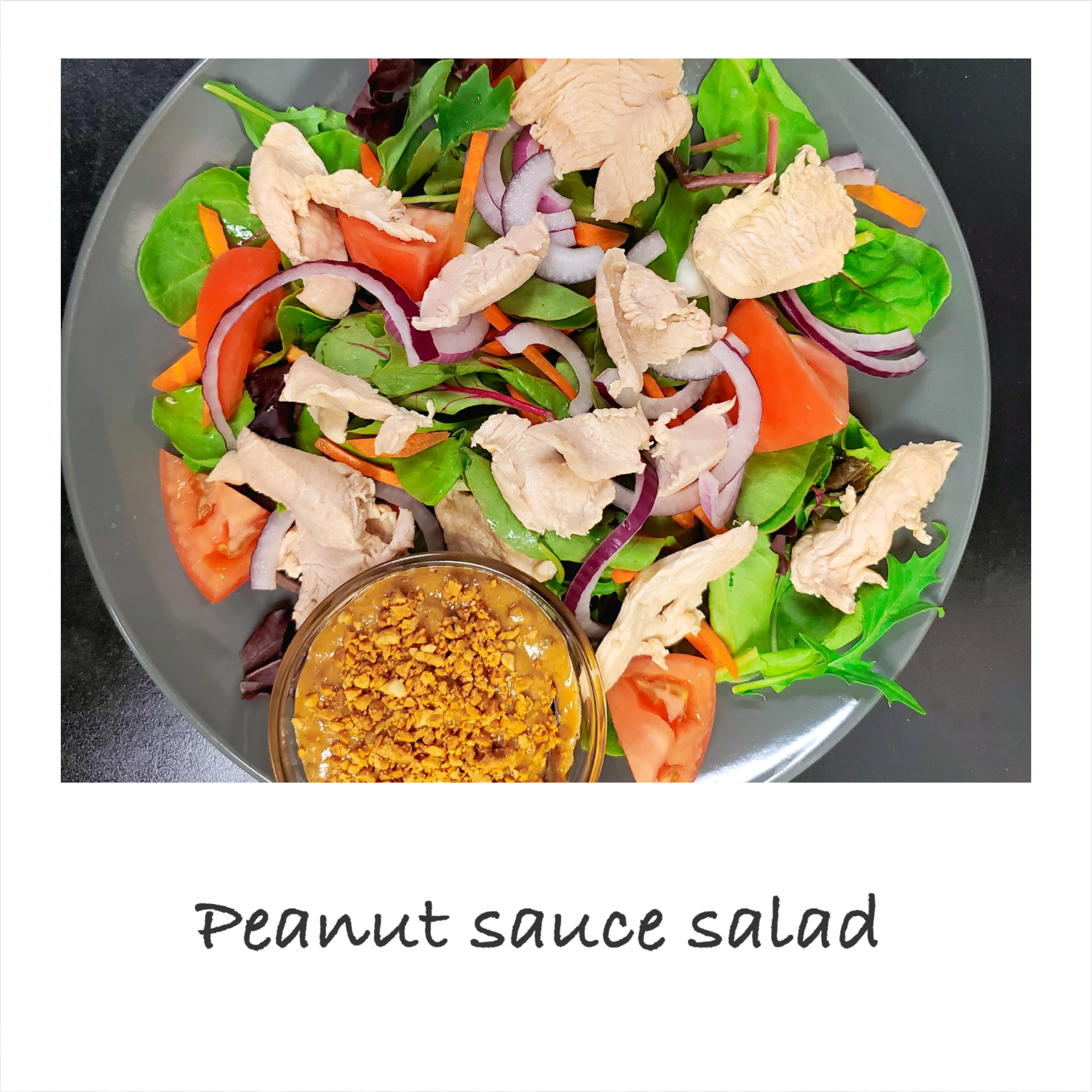 A salad with peanut sauce and chicken on a plate