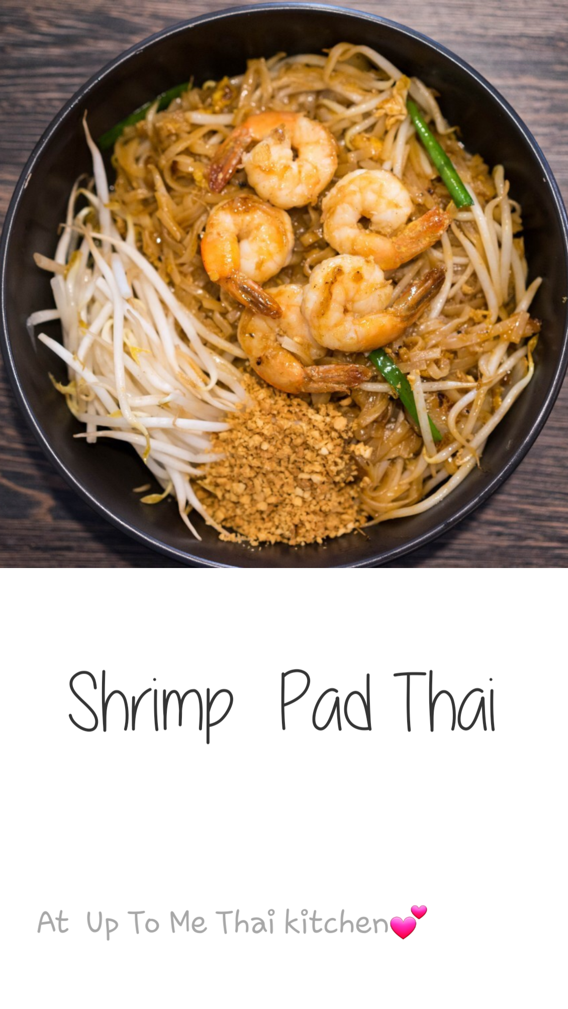A bowl of shrimp pad thai is sitting on a wooden table.