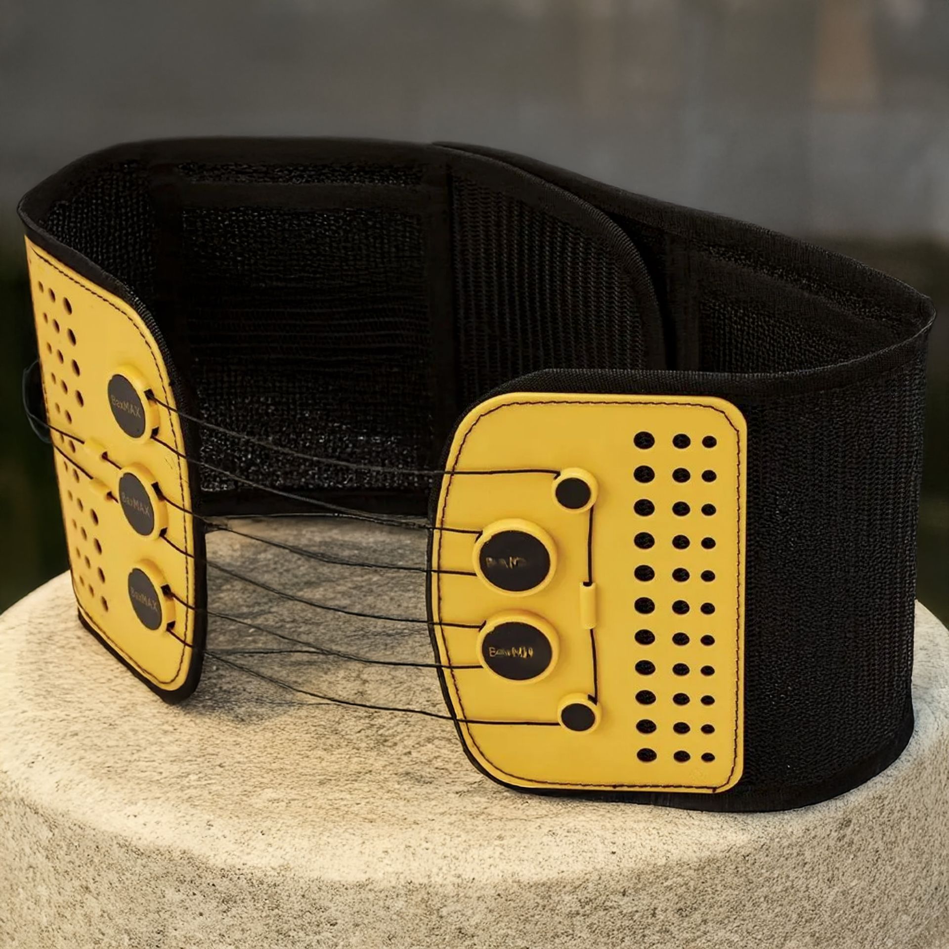 A black and yellow belt with holes in it