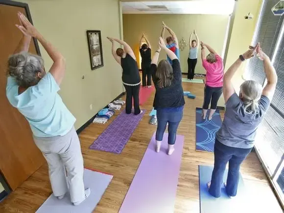 A group of women are doing yoga in a room