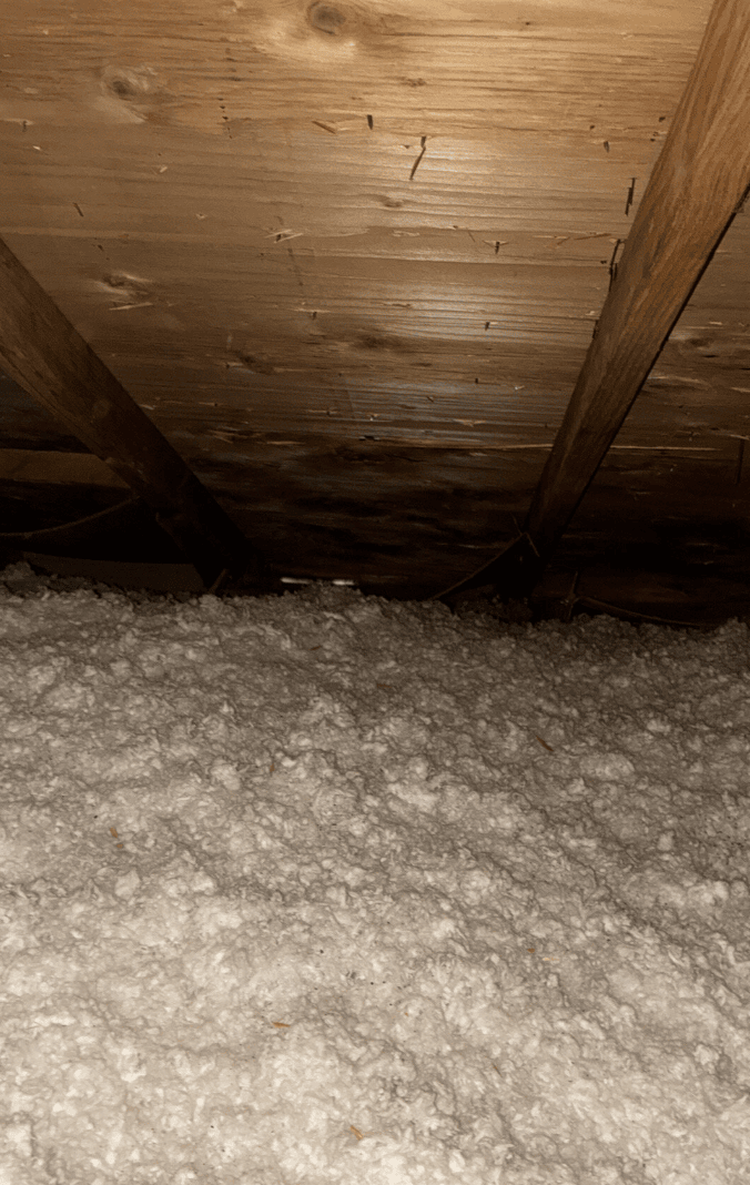 Close-up of water damage on bedroom ceiling