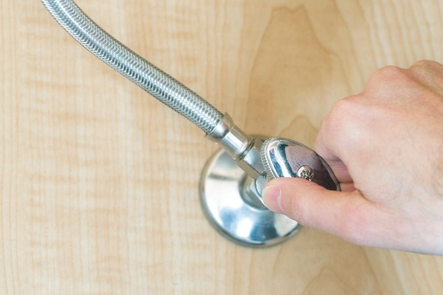 Water shutoff valve being turned